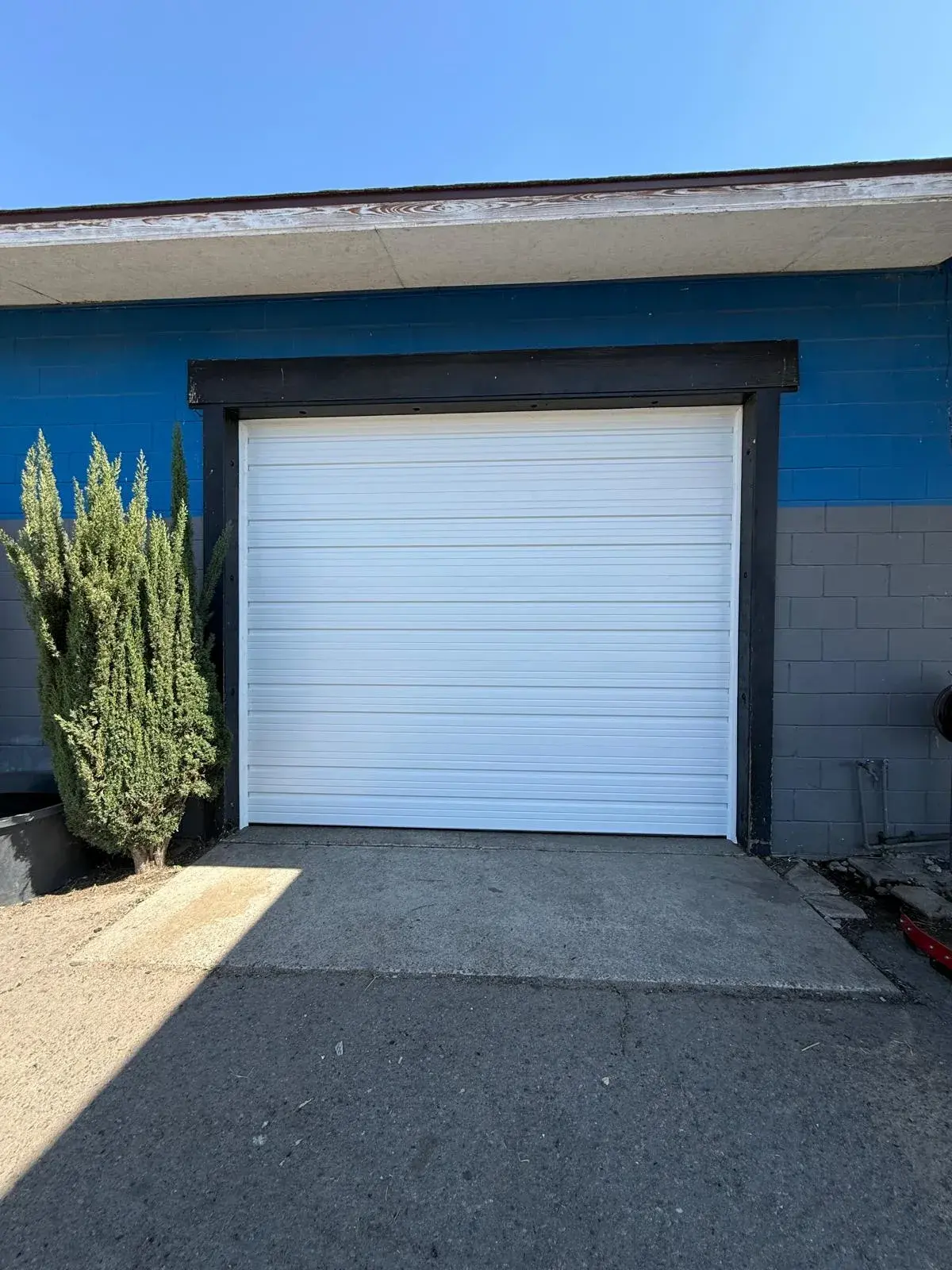 10x10 C.H.I. Model 3240 White Commercial Ribbed Steel Door Installation — Commercial track and hardware installation, spring balance, bottom seal setup, operation testing. Product/job: 10' x 10' whit