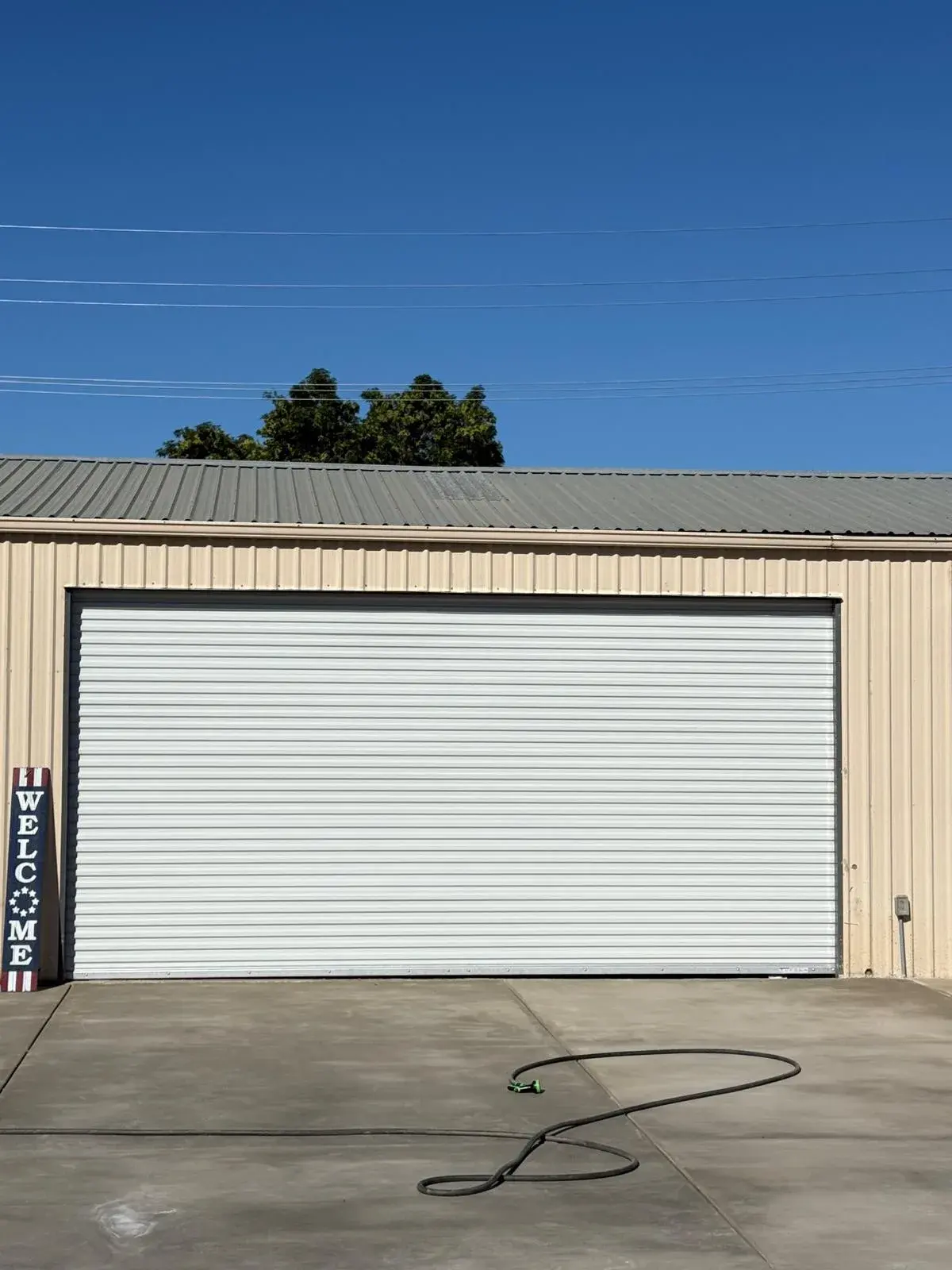 18x9 Janus Model 2500 White Commercial Roll-Up Door Installation — Roll-up barrel and curtain setup, guide alignment, chain or electric readiness, tensioning, final test. Product/job: 18' x 9' — aprof