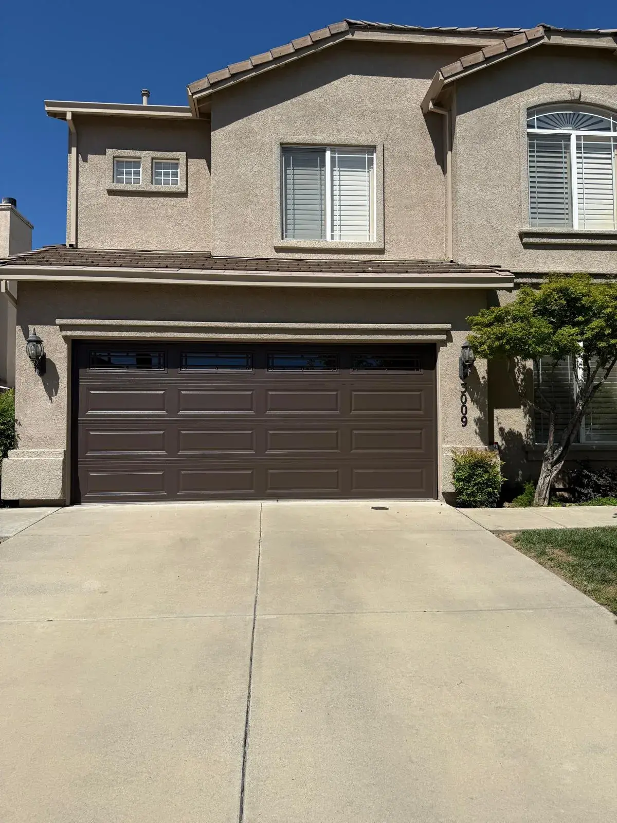 C.H.I. Model 4283 Walnut Wood Accent and 16x8 Brown Door with Prairie Windows — : custom finish selection, window inserts, insulated door setup, track and spring balancing. Product/job: C.H.I. Model 4