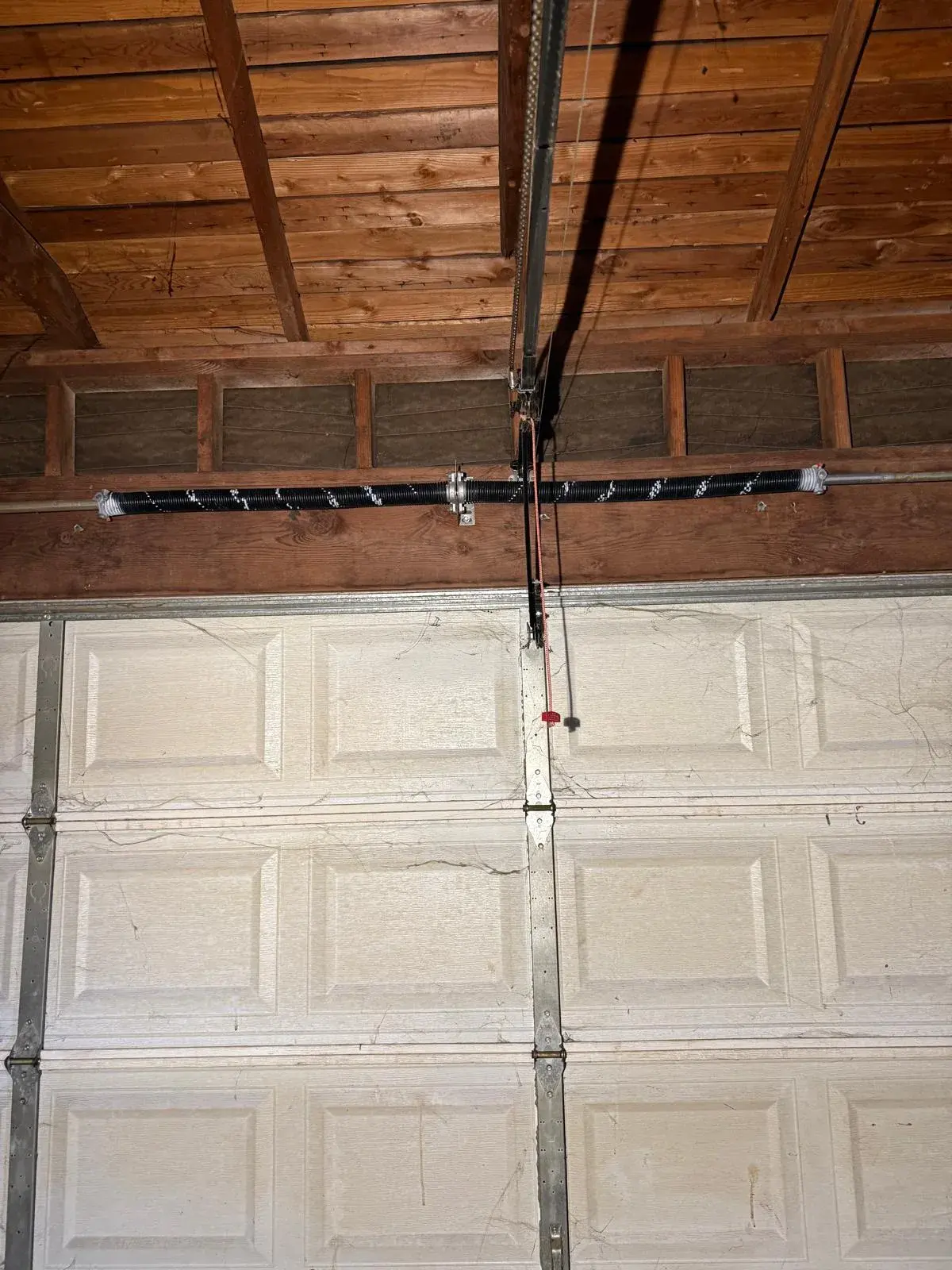 Converting a Two-Car Garage Door from One Spring to a Dual-Spring System — Spring sizing, torsion spring replacement, cable check, balance correction, opener strain reduction. Product: two-car garage