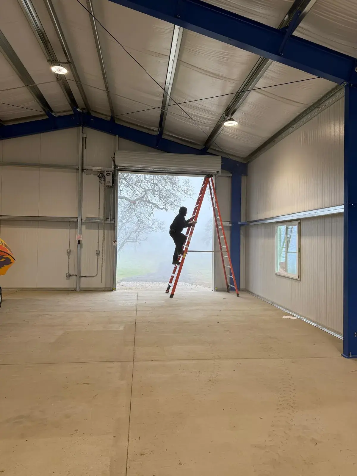 Four 12x14 Insulated Janus Roll-Up Doors for a Custom Metal Building — Multi-opening measurement, guide and barrel installation, insulated curtain setup, seal verification, final testing. Product/ — a