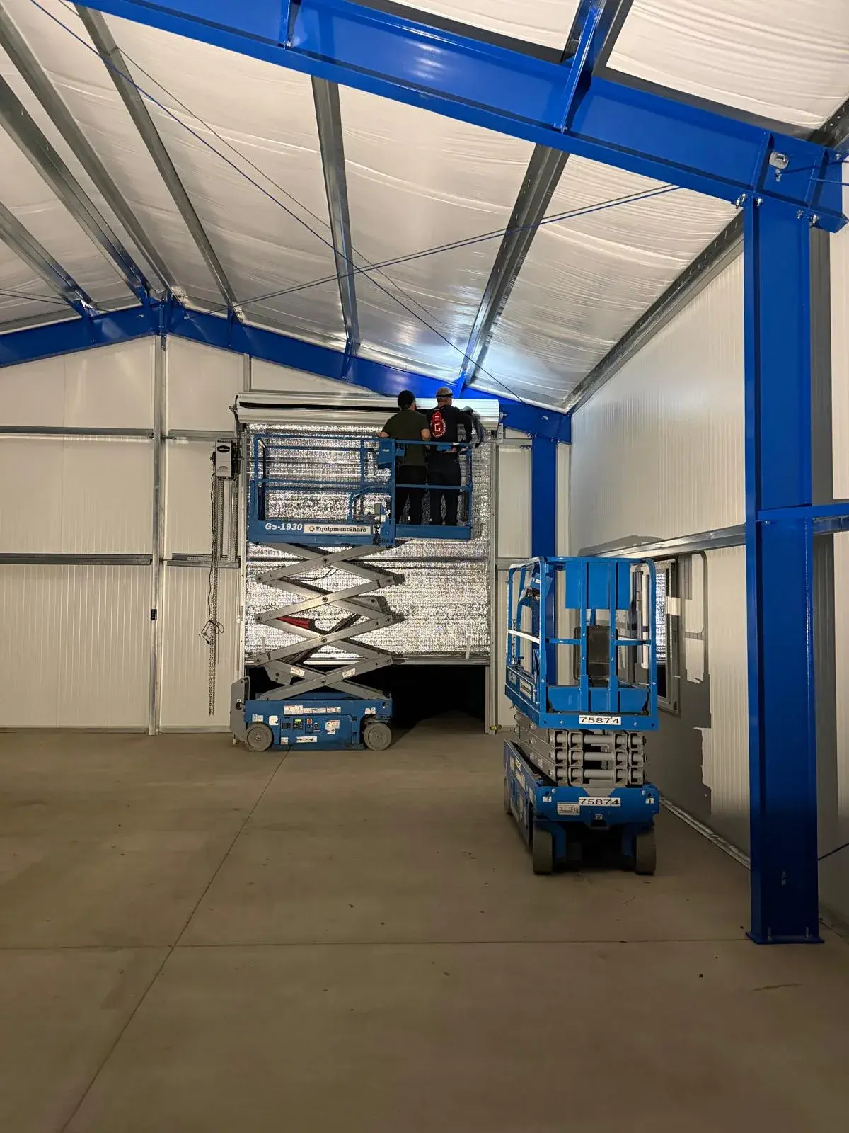 Four 12x14 Insulated Janus Roll-Up Doors for a Custom Metal Building — Multi-opening measurement, guide and barrel installation, insulated curtain setup, seal verification, final testing. Product/ — a