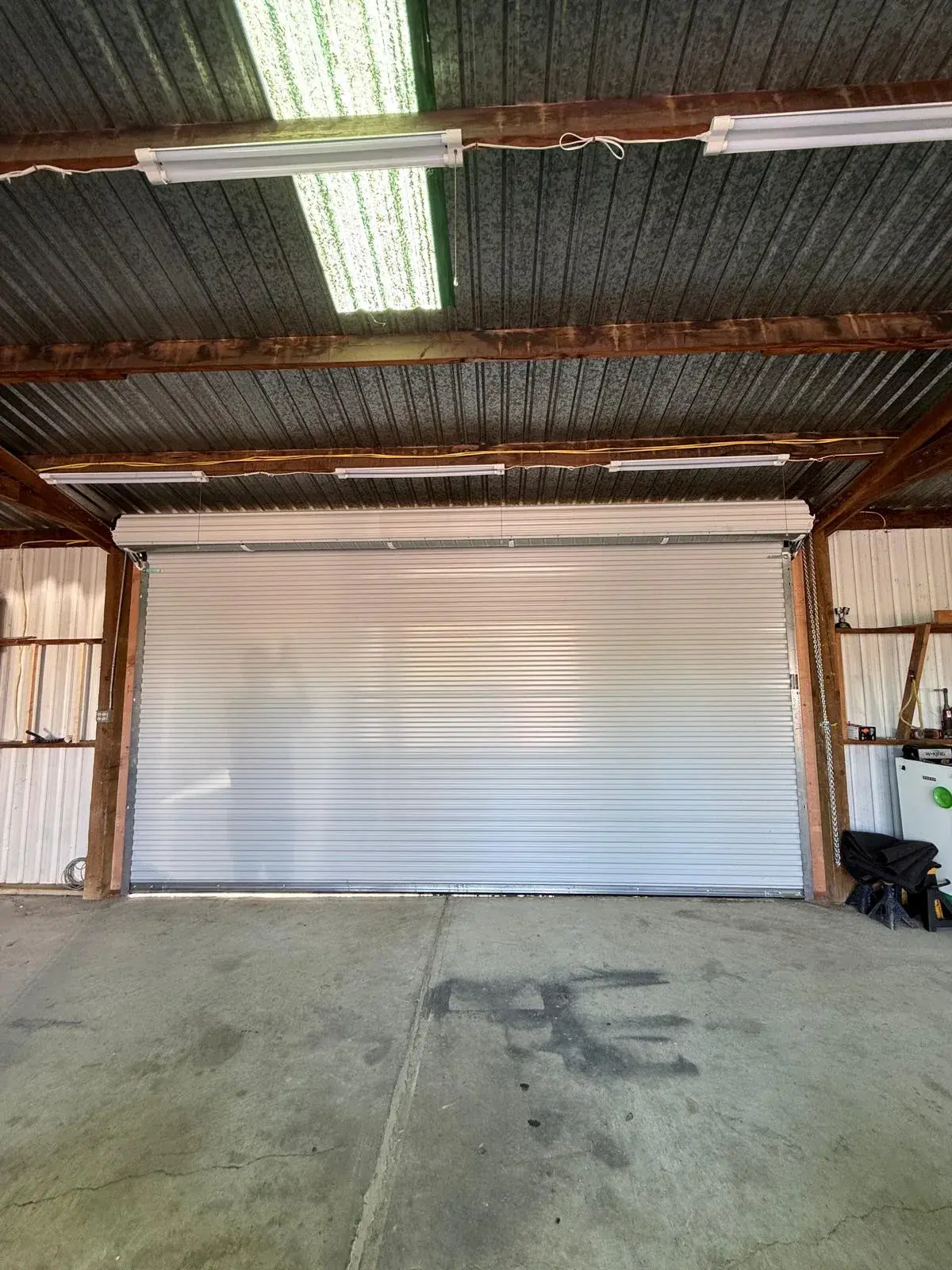 18x9 Janus Model 2500 White Commercial Roll-Up Door Installation — Roll-up barrel and curtain setup, guide alignment, chain or electric readiness, tensioning, final test. Product/job: 18' x 9' — aprof