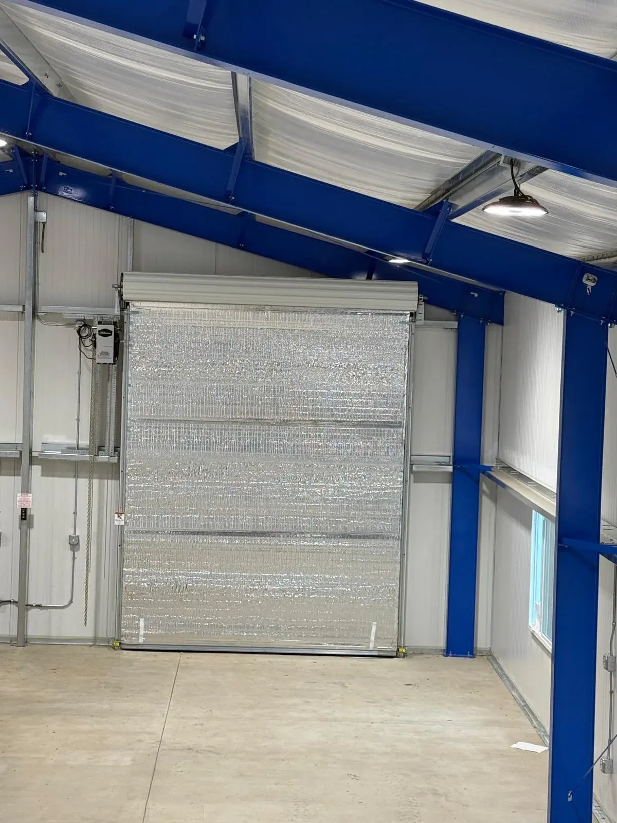 Four 12x14 Insulated Janus Roll-Up Doors for a Custom Metal Building — Multi-opening measurement, guide and barrel installation, insulated curtain setup, seal verification, final testing. Product/ — a