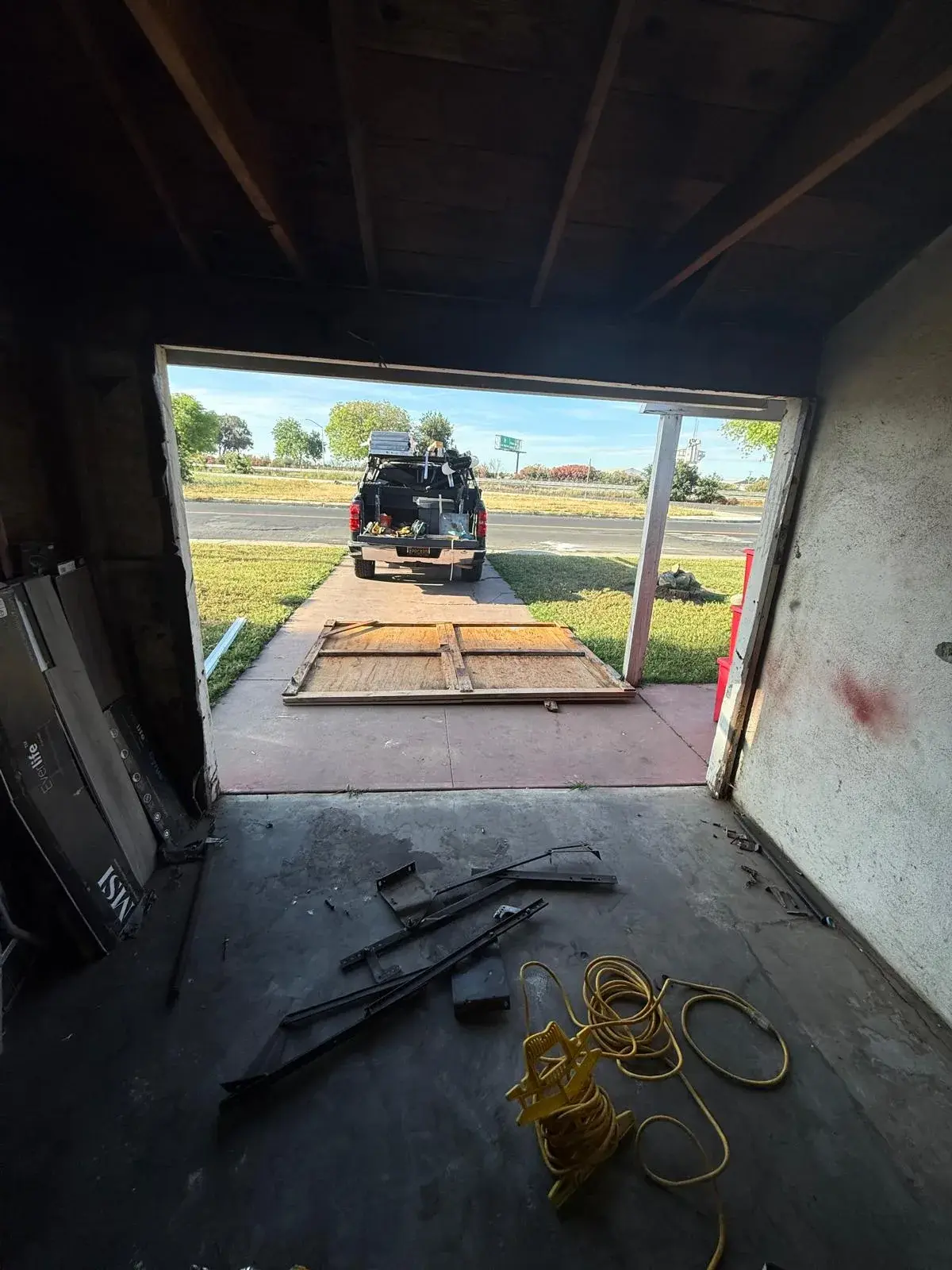 Replacing an Old One-Piece Wood Door with a 9x7 C.H.I. Model 4250 Sectional Door — One-piece wood door removal, sectional conversion, new track and hardware, torsion spring balance. Product/job: 9' x