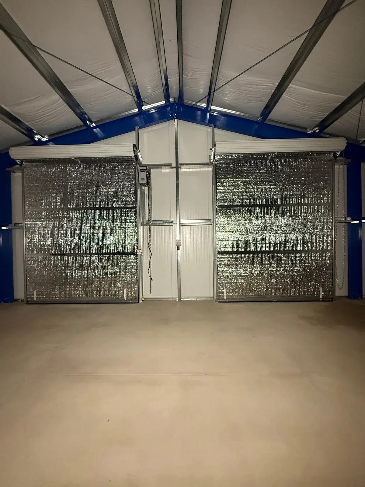 Four 12x14 Insulated Janus Roll-Up Doors for a Custom Metal Building — Multi-opening measurement, guide and barrel installation, insulated curtain setup, seal verification, final testing. Product/ — a