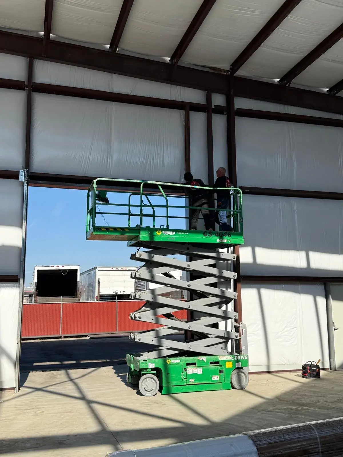 12x14 Janus Roll-Up Door Installation for a Commercial Metal Building — Metal building door installation, guide and bracket mounting, barrel and curtain setup, chain hoist alignment. Product/job: 1 —