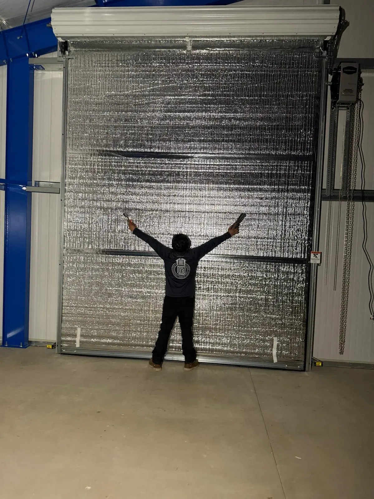 Four 12x14 Insulated Janus Roll-Up Doors for a Custom Metal Building — Multi-opening measurement, guide and barrel installation, insulated curtain setup, seal verification, final testing. Product/ — a