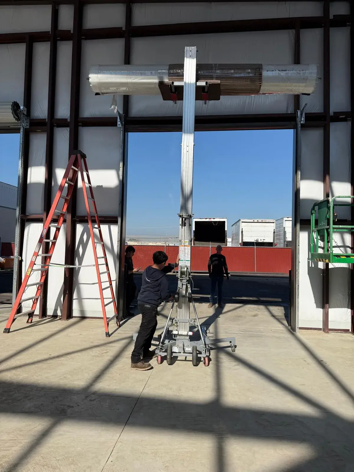 12x14 Janus Roll-Up Door Installation for a Commercial Metal Building — Metal building door installation, guide and bracket mounting, barrel and curtain setup, chain hoist alignment. Product/job: 1 —