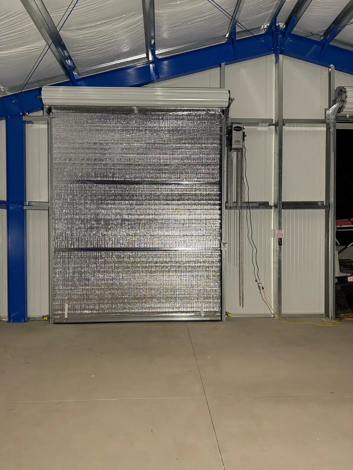 Four 12x14 Insulated Janus Roll-Up Doors for a Custom Metal Building — Multi-opening measurement, guide and barrel installation, insulated curtain setup, seal verification, final testing. Product/ — a