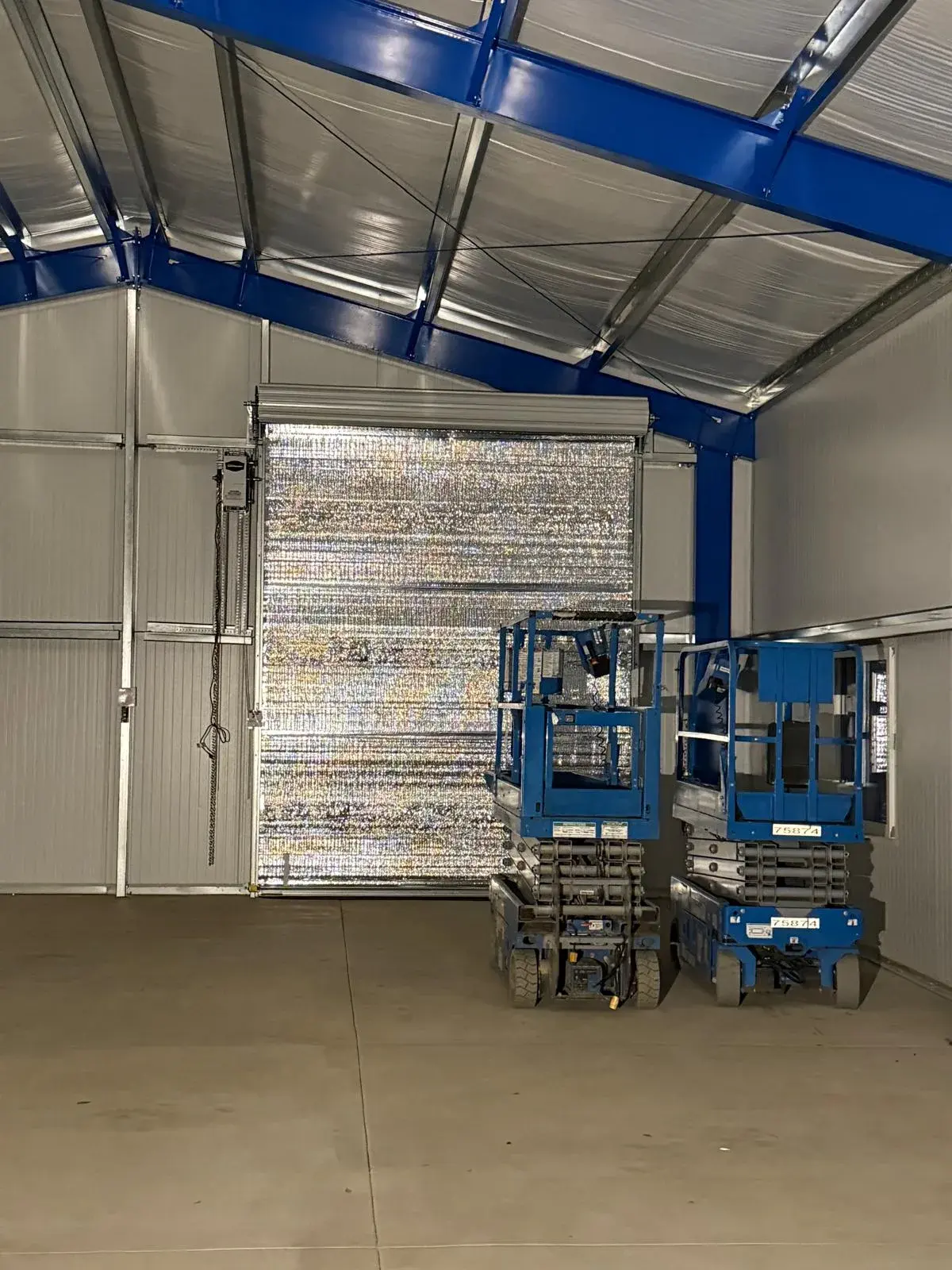 Four 12x14 Insulated Janus Roll-Up Doors for a Custom Metal Building — Multi-opening measurement, guide and barrel installation, insulated curtain setup, seal verification, final testing. Product/ — a