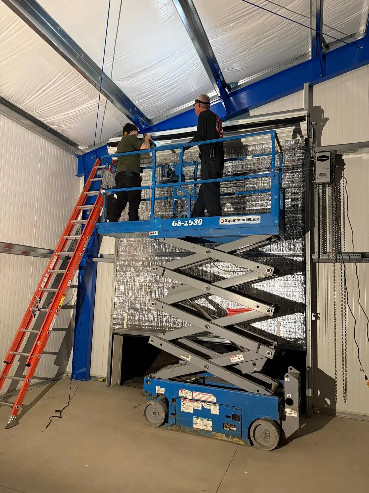Four 12x14 Insulated Janus Roll-Up Doors for a Custom Metal Building — Multi-opening measurement, guide and barrel installation, insulated curtain setup, seal verification, final testing. Product/ — a