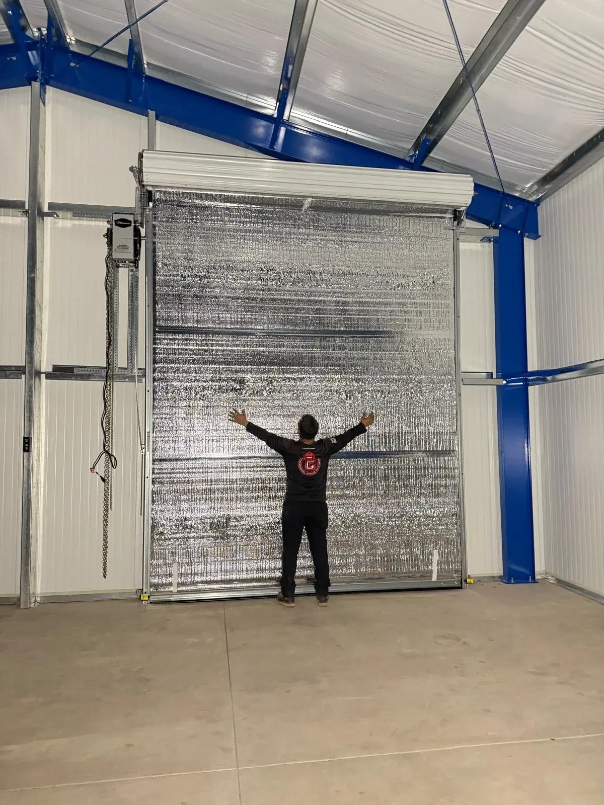 Four 12x14 Insulated Janus Roll-Up Doors for a Custom Metal Building — Multi-opening measurement, guide and barrel installation, insulated curtain setup, seal verification, final testing. Product/ — a