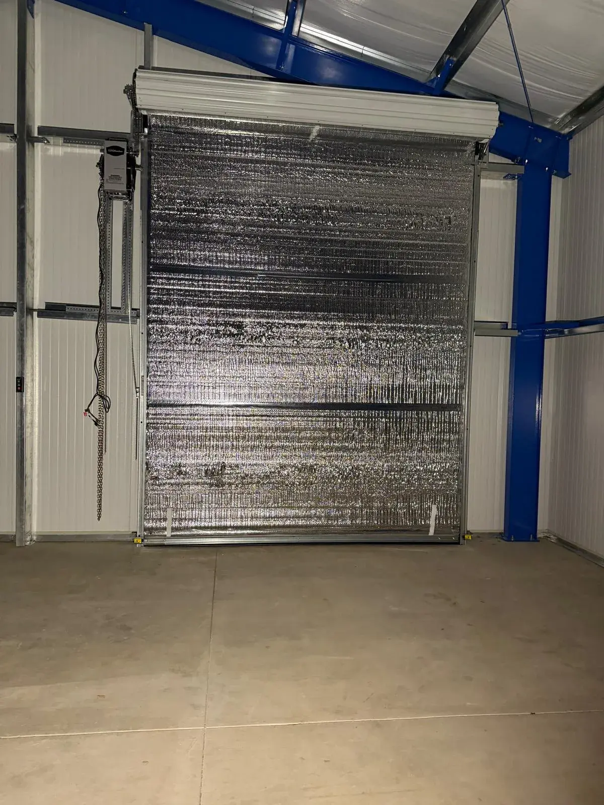 Four 12x14 Insulated Janus Roll-Up Doors for a Custom Metal Building — Multi-opening measurement, guide and barrel installation, insulated curtain setup, seal verification, final testing. Product/ — a