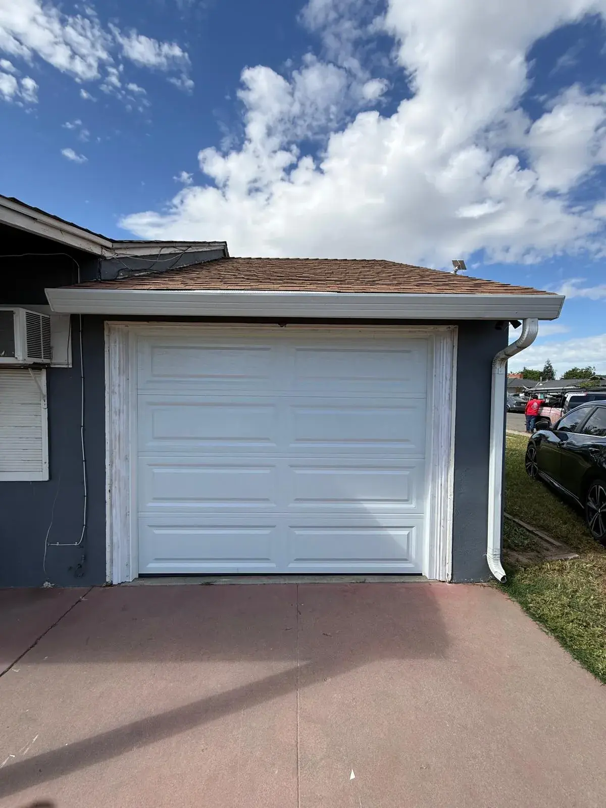 Replacing an Old One-Piece Wood Door with a 9x7 C.H.I. Model 4250 Sectional Door — One-piece wood door removal, sectional conversion, new track and hardware, torsion spring balance. Product/job: 9' x